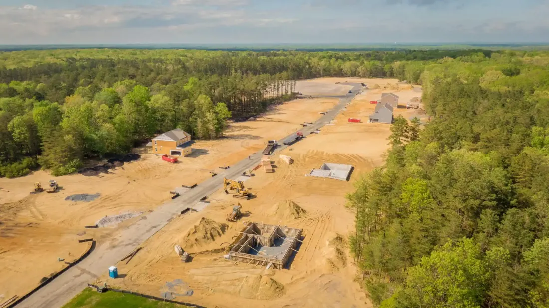Heavy equipment and trailer on a land-improvement job site